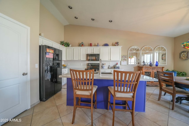 tiled dining area with vaulted ceiling