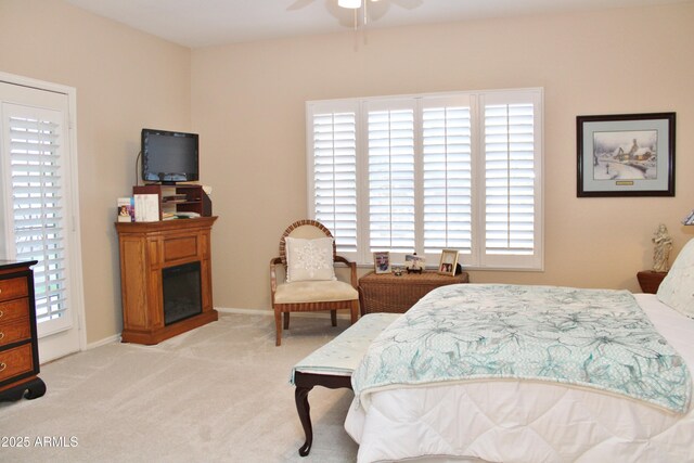 bedroom with light carpet and ceiling fan