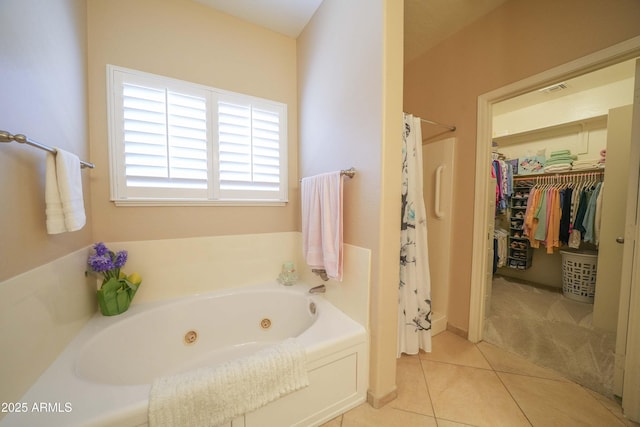 bathroom with tile patterned flooring and shower with separate bathtub