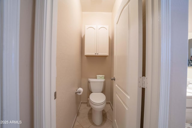 bathroom featuring toilet and tile patterned floors