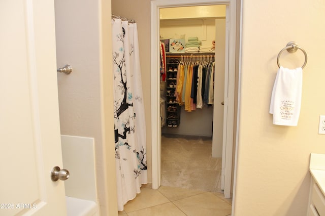 bathroom featuring tile patterned flooring, vanity, and a shower with curtain