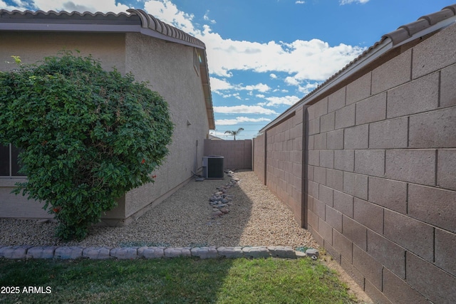 view of side of home with central AC unit