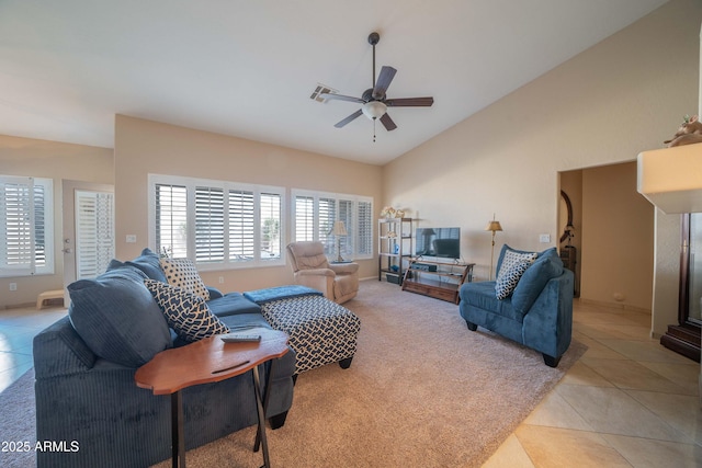 tiled living room with ceiling fan and vaulted ceiling