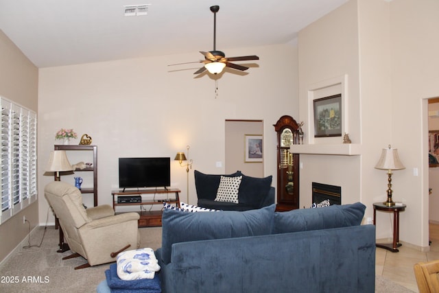 living room featuring ceiling fan and vaulted ceiling