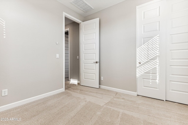 unfurnished bedroom with light carpet, baseboards, and visible vents