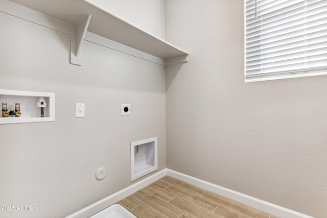 clothes washing area featuring baseboards, washer hookup, laundry area, wood finish floors, and electric dryer hookup
