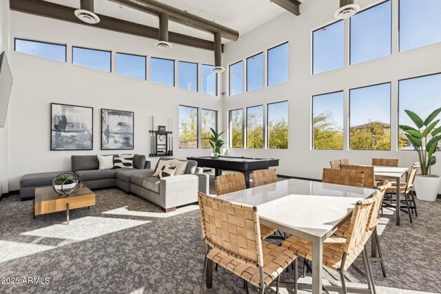 interior space featuring a high ceiling, pool table, beam ceiling, and carpet floors