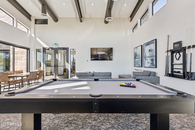 playroom featuring french doors, beamed ceiling, billiards, and a towering ceiling