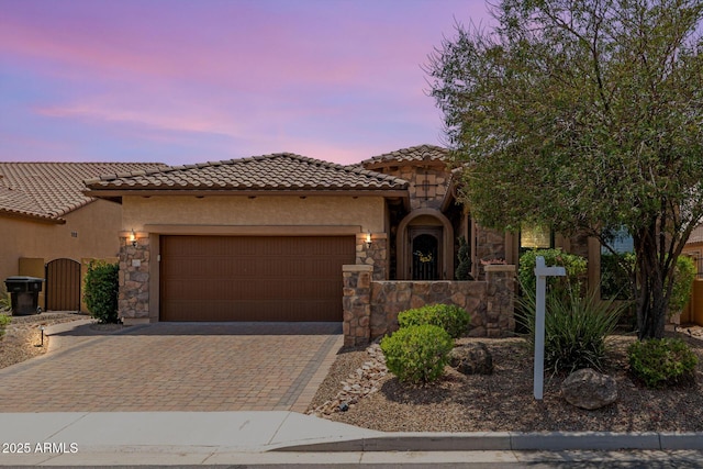 1822 N Waverly, Mesa, AZ 85207 - mediterranean / spanish home with a garage, stucco siding, a tiled roof, decorative driveway, and stone siding