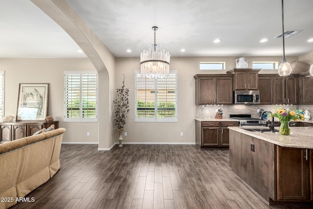 1822 N Waverly, Mesa, AZ 85207 - kitchen featuring stainless steel appliances, dark wood finished floors, arched walkways, open floor plan, and dark brown cabinetry