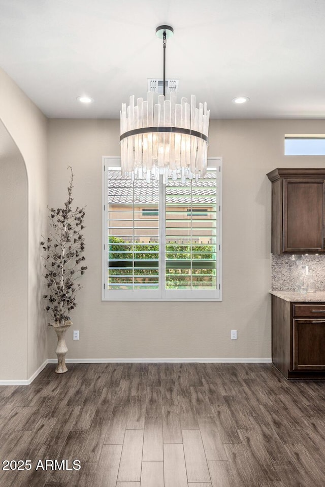 1822 N Waverly, Mesa, AZ 85207 - unfurnished dining area with dark wood finished floors, healthy amount of natural light, arched walkways, and recessed lighting