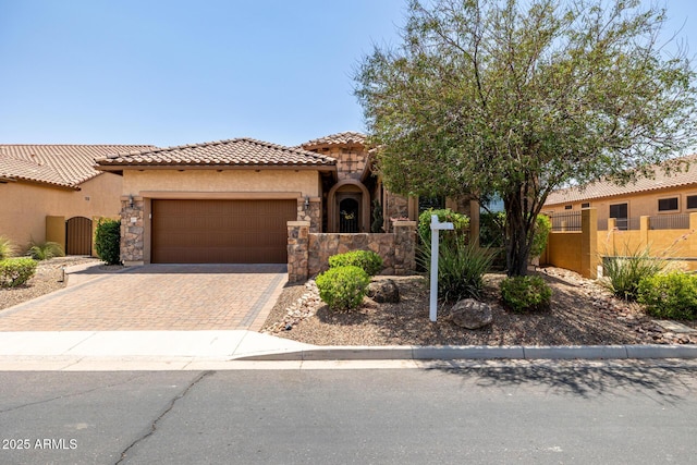 1822 N Waverly, Mesa, AZ 85207 - mediterranean / spanish-style home with a tiled roof, stucco siding, an attached garage, decorative driveway, and stone siding
