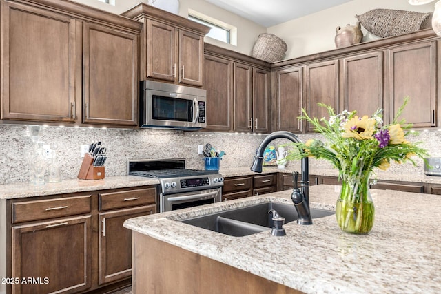 1822 N Waverly, Mesa, AZ 85207 - kitchen with stainless steel appliances, backsplash, light stone countertops, and dark brown cabinets