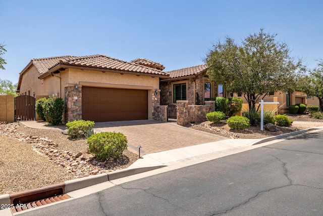 1822 N Waverly, Mesa, AZ 85207 - view of front facade with a gate, an attached garage, stucco siding, decorative driveway, and stone siding