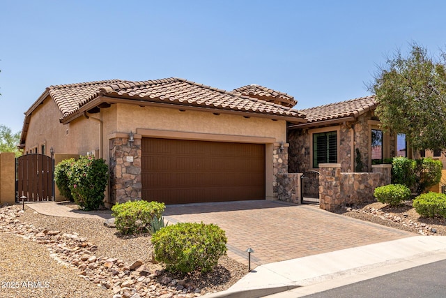 1822 N Waverly, Mesa, AZ 85207 - mediterranean / spanish-style house featuring a gate, stone siding, a garage, and decorative driveway