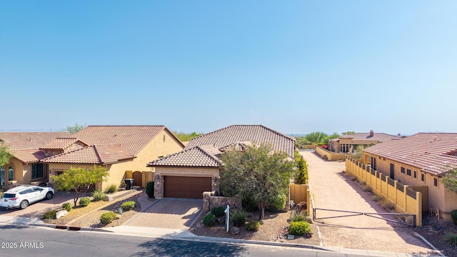 1822 N Waverly, Mesa, AZ 85207 - mediterranean / spanish-style house featuring stucco siding, a tile roof, an attached garage, driveway, and stone siding