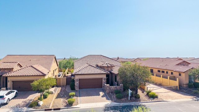 1822 N Waverly, Mesa, AZ 85207 - mediterranean / spanish house featuring an attached garage, a tile roof, stone siding, stucco siding, and driveway