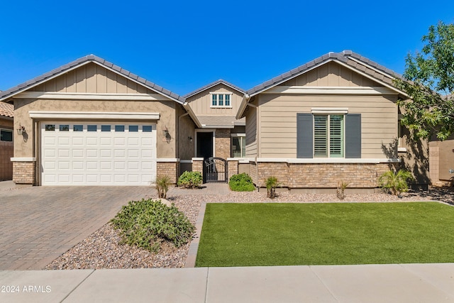 view of front of house with a garage and a front lawn