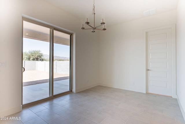 empty room featuring a notable chandelier