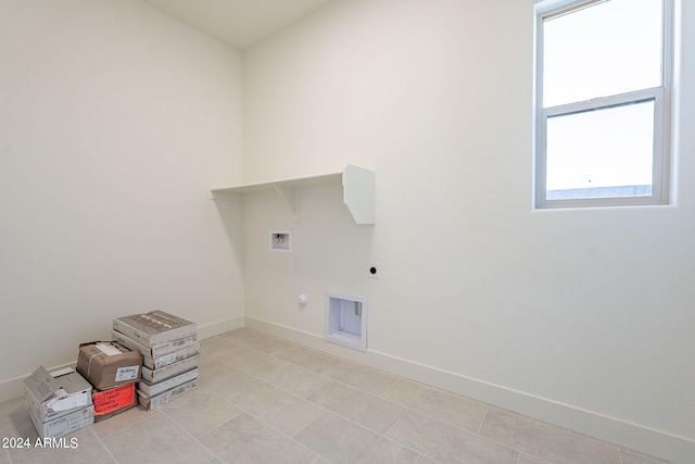 clothes washing area with hookup for a gas dryer, washer hookup, and hookup for an electric dryer