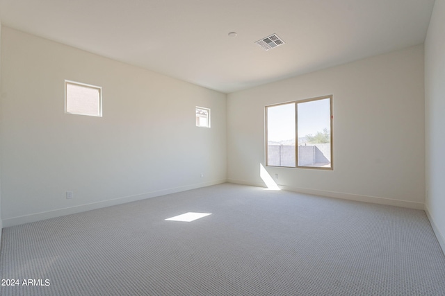 unfurnished room with light colored carpet