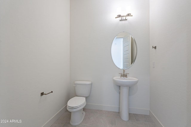 bathroom with tile patterned floors and toilet