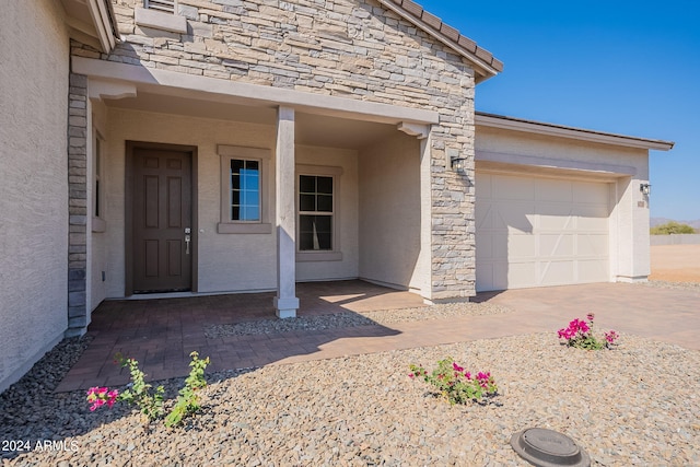 view of exterior entry with a garage