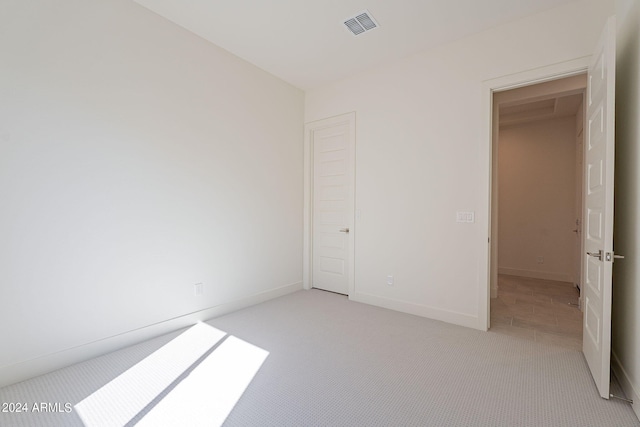 unfurnished bedroom with light carpet