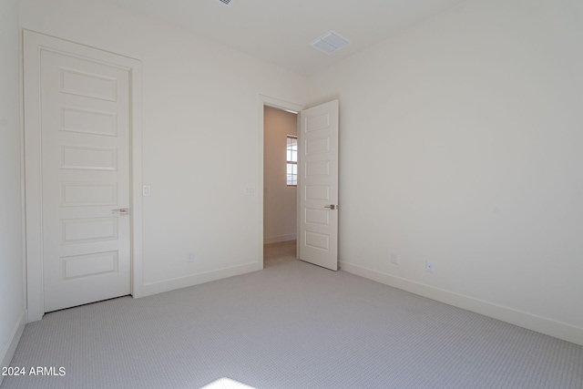 unfurnished bedroom with light carpet