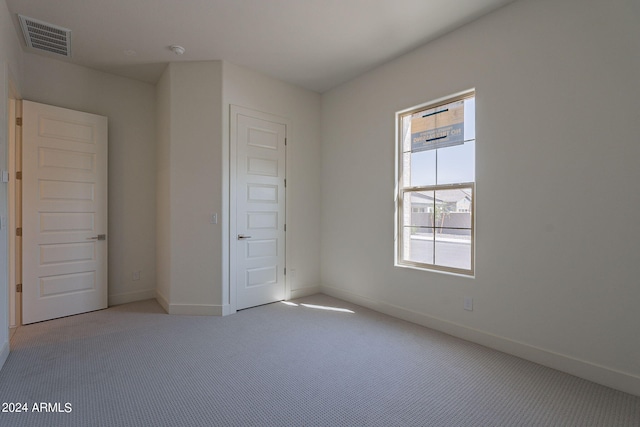 unfurnished bedroom with light colored carpet