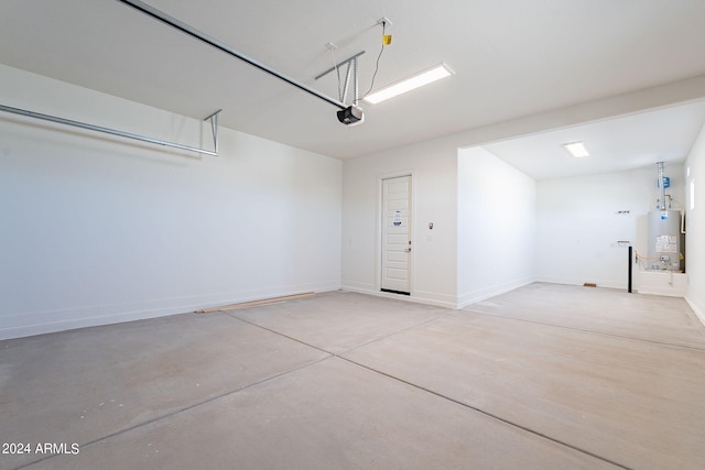 garage featuring a garage door opener and water heater