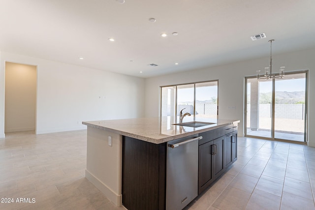 kitchen featuring pendant lighting, sink, a kitchen island with sink, plenty of natural light, and stainless steel dishwasher