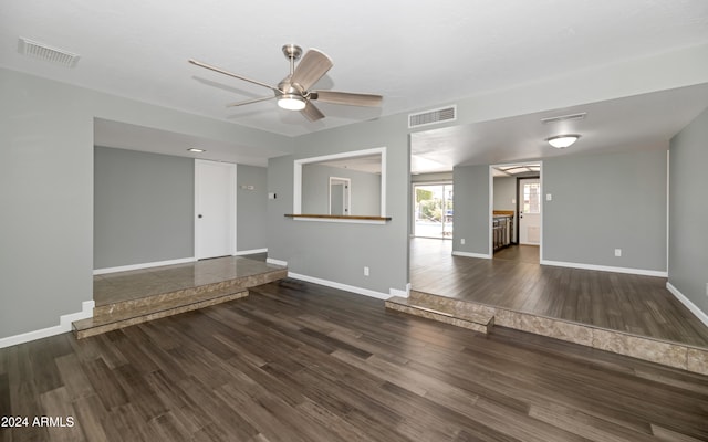 unfurnished living room with ceiling fan and dark hardwood / wood-style flooring