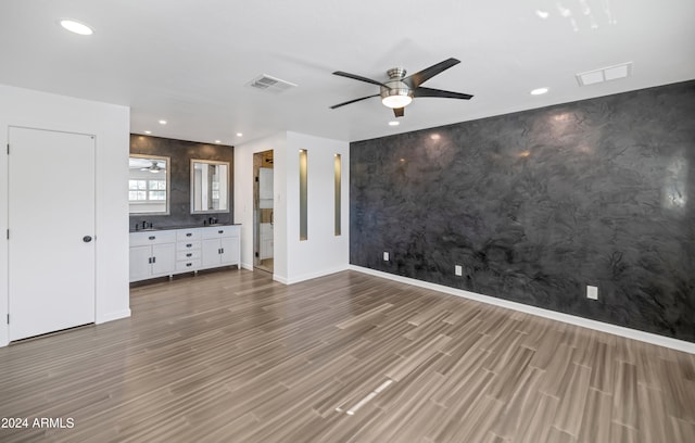 unfurnished bedroom featuring wood-type flooring and ceiling fan