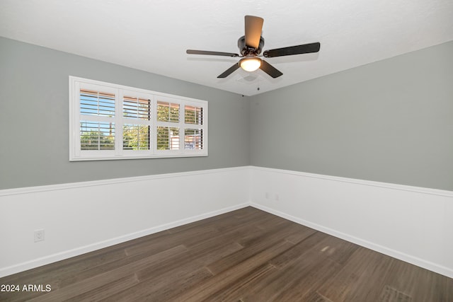 empty room with dark hardwood / wood-style floors and ceiling fan