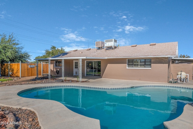 view of swimming pool with a patio and central AC unit