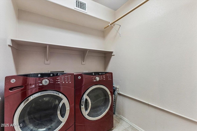 laundry room featuring washer and clothes dryer and baseboards