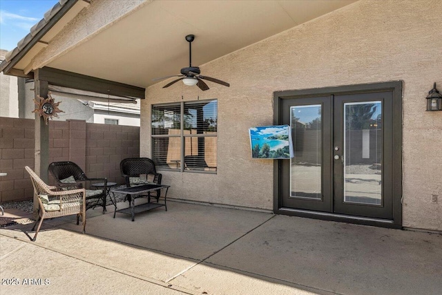 view of patio with french doors, fence, and a ceiling fan