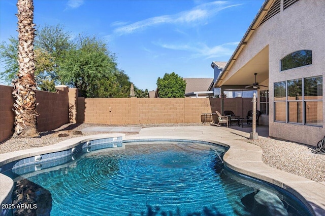 view of swimming pool with a ceiling fan, a fenced backyard, and a patio area