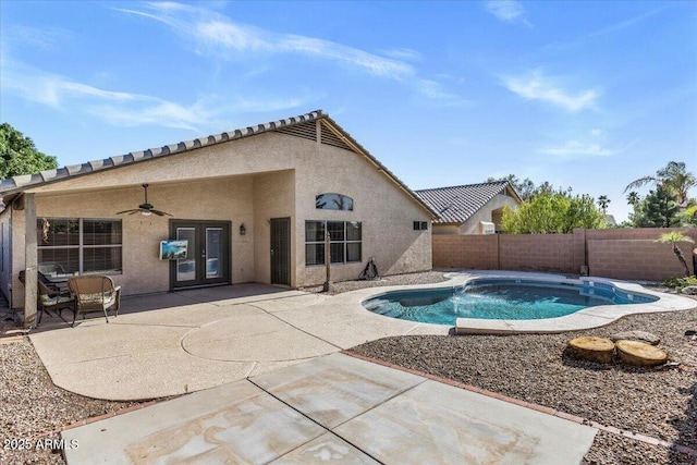 view of swimming pool featuring a fenced backyard, ceiling fan, french doors, and a patio