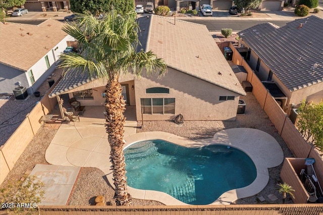 view of swimming pool with a fenced backyard and a patio