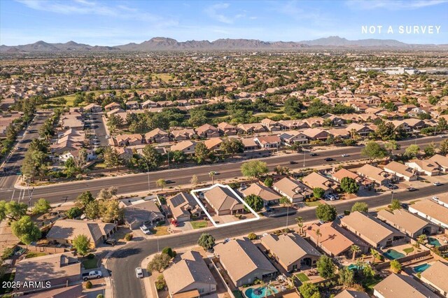 aerial view of property's location featuring mountains and nearby suburban area