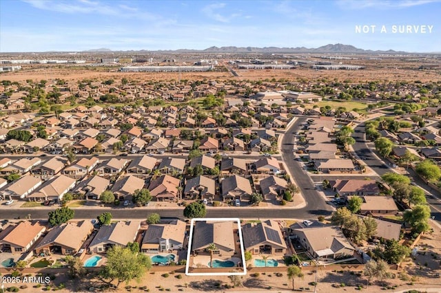 view of property location featuring mountains and nearby suburban area