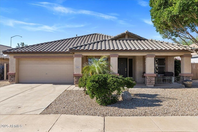 view of front of property featuring concrete driveway, stucco siding, a garage, and a porch