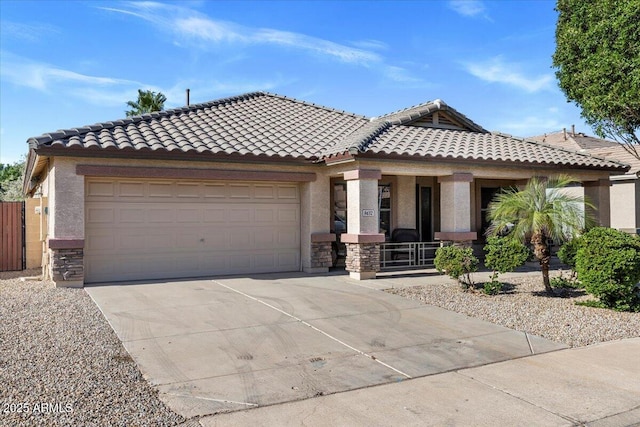 view of front of home with a porch, stucco siding, driveway, and an attached garage