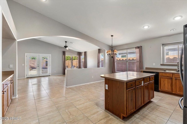 kitchen with arched walkways, dishwasher, open floor plan, plenty of natural light, and recessed lighting