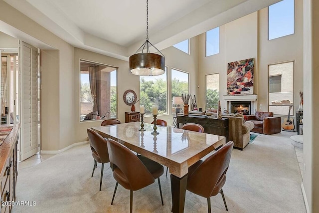27892 N 108th Way, Scottsdale, AZ 85262 - dining room featuring light carpet, a warm lit fireplace, and baseboards