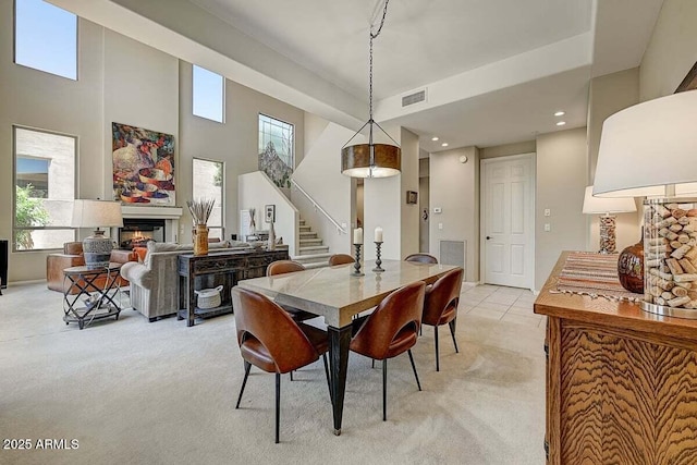 27892 N 108th Way, Scottsdale, AZ 85262 - dining area with light carpet, stairway, a lit fireplace, healthy amount of natural light, and recessed lighting