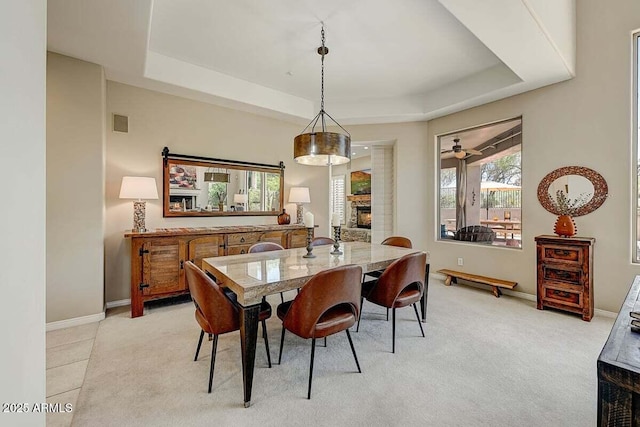 27892 N 108th Way, Scottsdale, AZ 85262 - dining space featuring a raised ceiling, a fireplace, healthy amount of natural light, and light colored carpet
