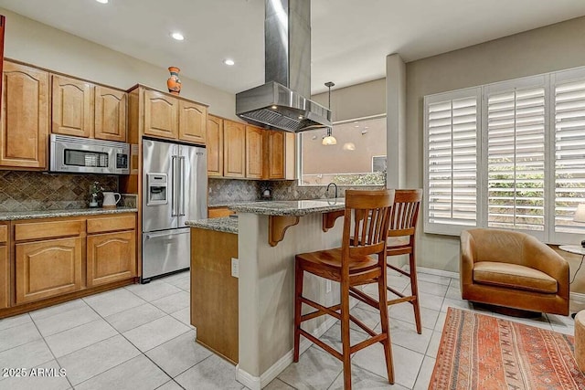 27892 N 108th Way, Scottsdale, AZ 85262 - kitchen with appliances with stainless steel finishes, island range hood, light tile patterned floors, tasteful backsplash, and stone counters
